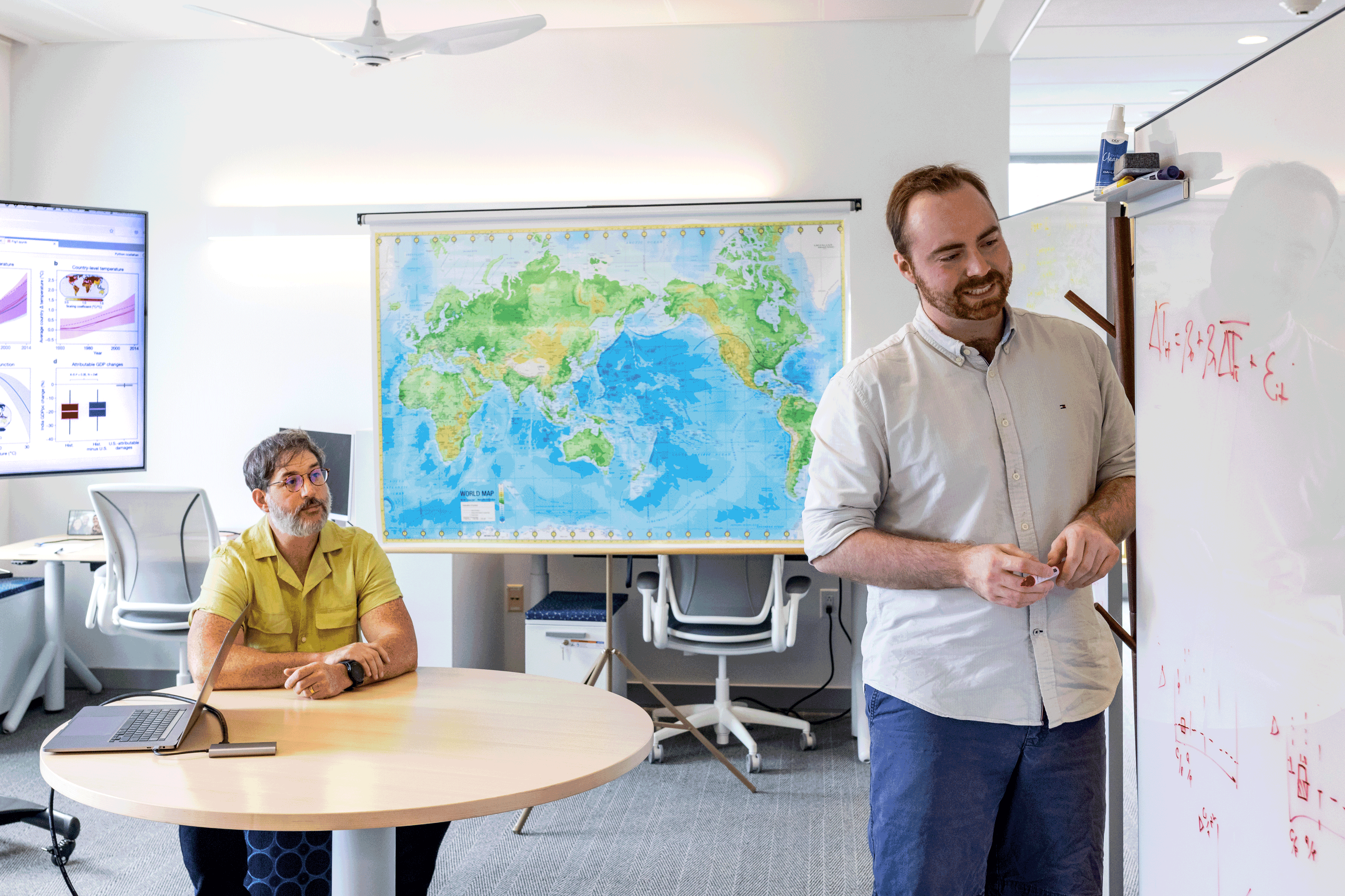 Justin Mankin and Christopher Callahan working at a white board