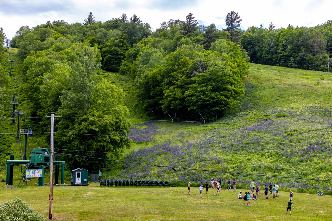 Students playing soccer at the base of Holts Ledges