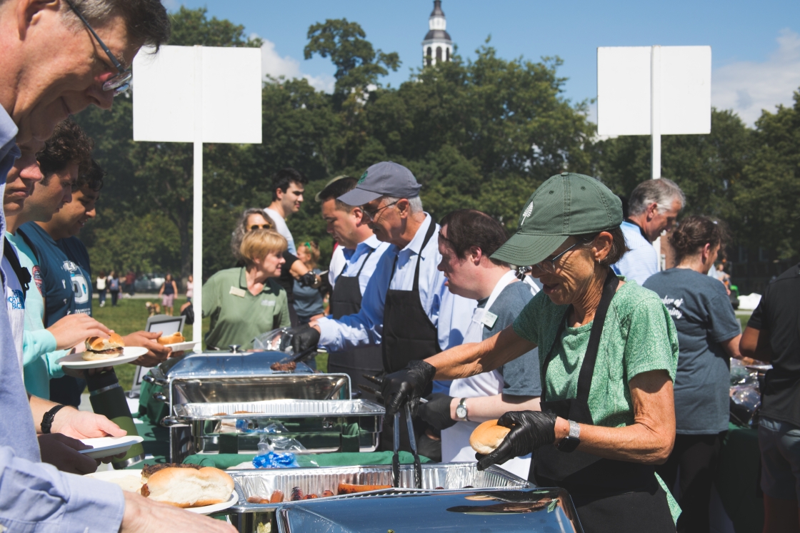 The Hanlons serving food to a line of Dartmouth community members