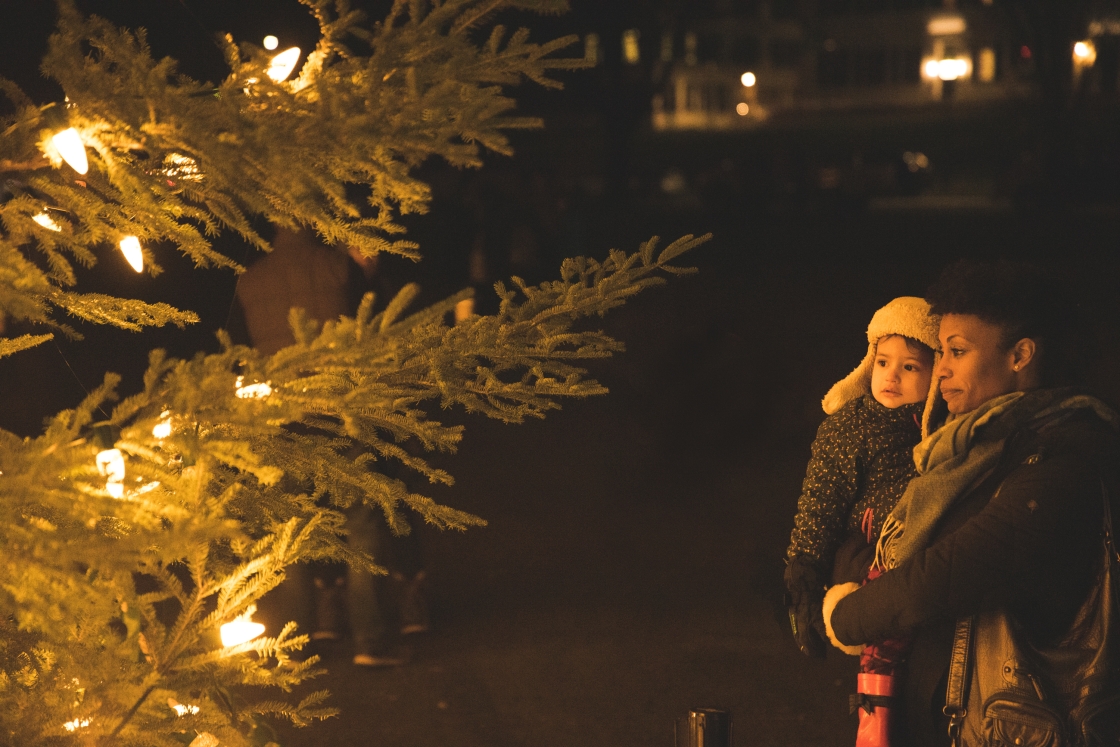 Woman and child closely admiring the Christmas tree