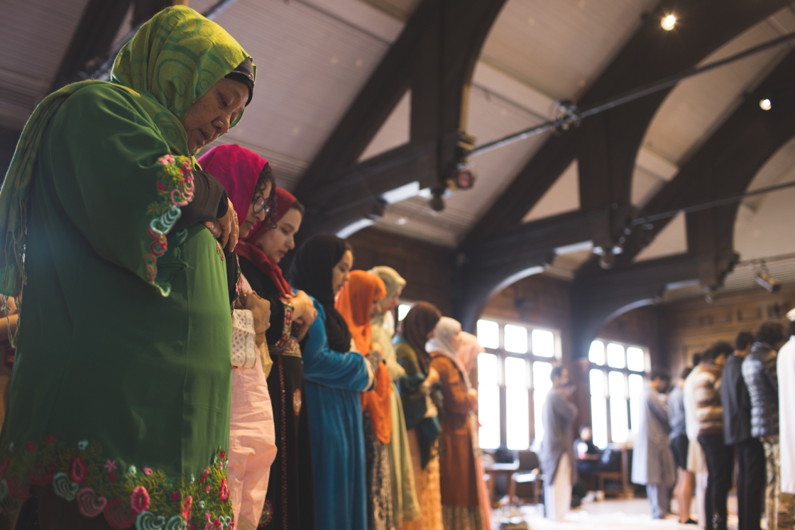 People in colorful traditional dress praying