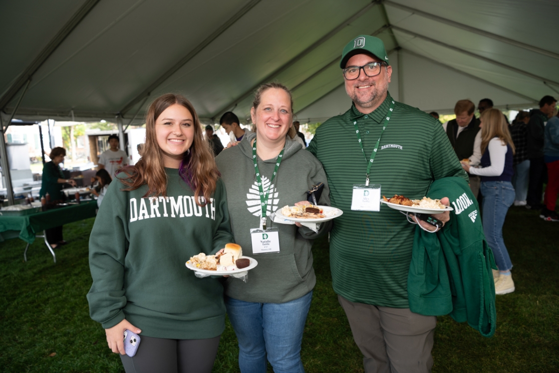 Family poses with plates of food