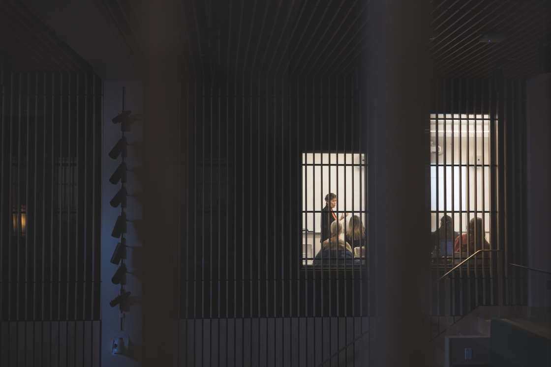 Classroom viewed through dark lighting and steel bars