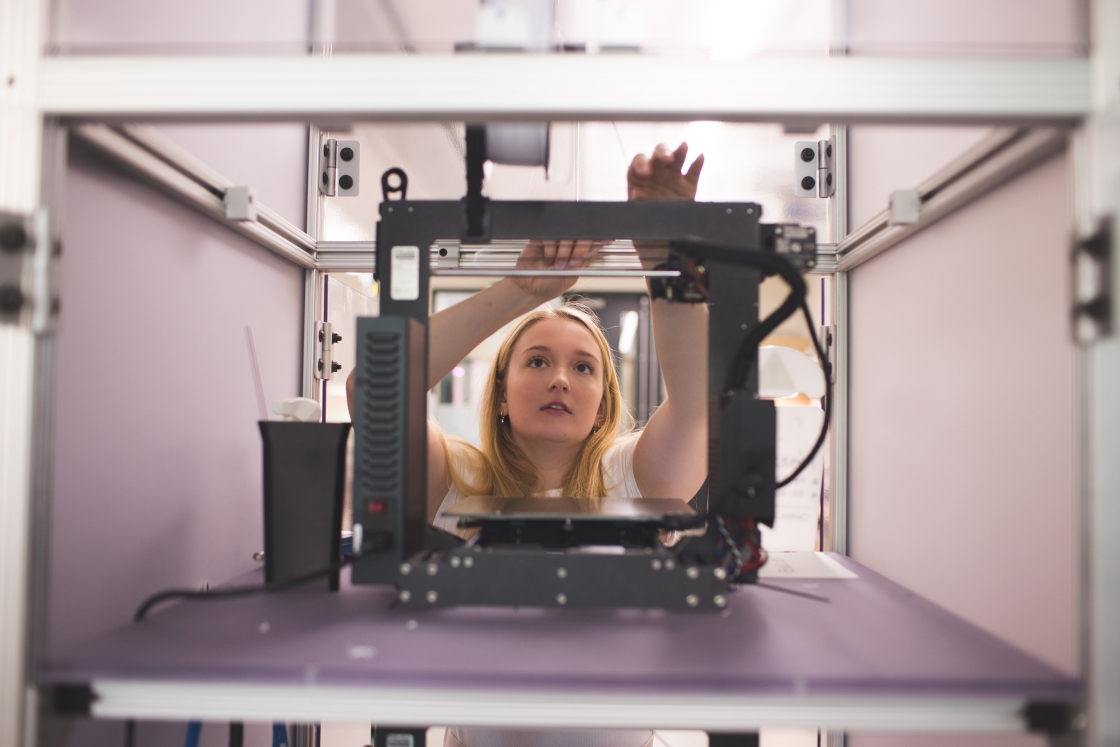 Student working at a 3D printer