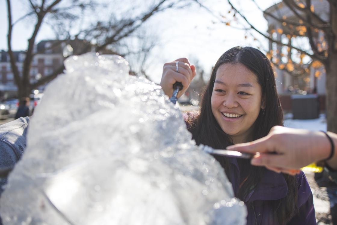 Students carving an ice sculpture