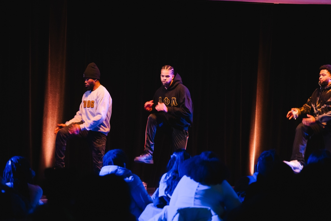 Alpha Phi Alpha fraternity performs onstage