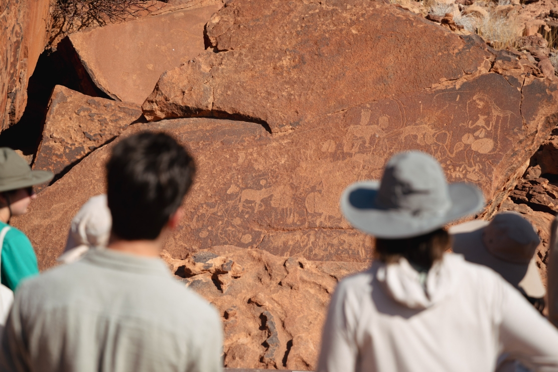 Students look at a landscape with engravings