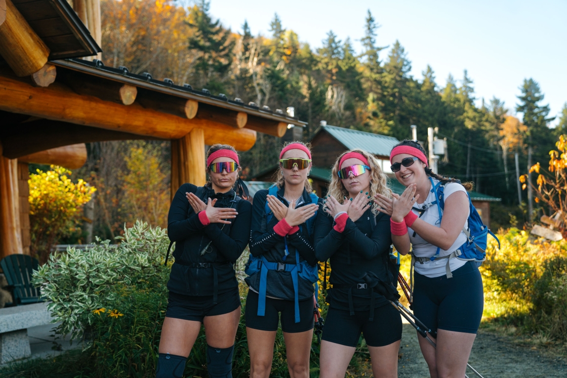 Group of women dressed in sunglasses and headbands outside the lodge