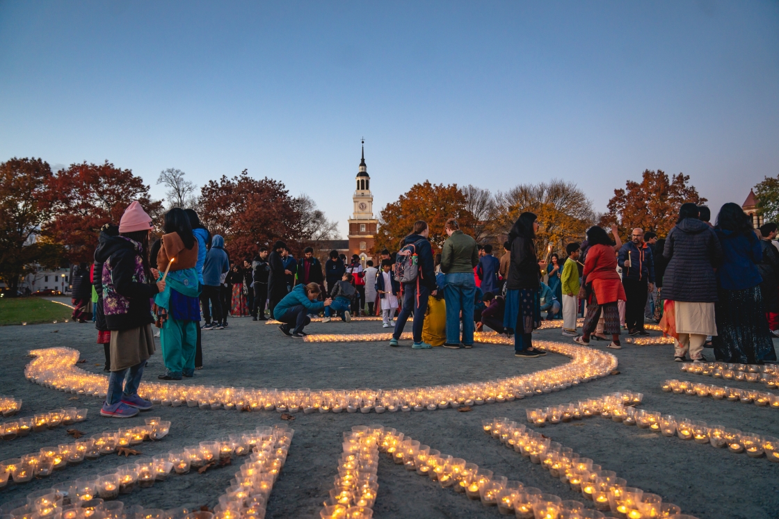 People gathered around candles