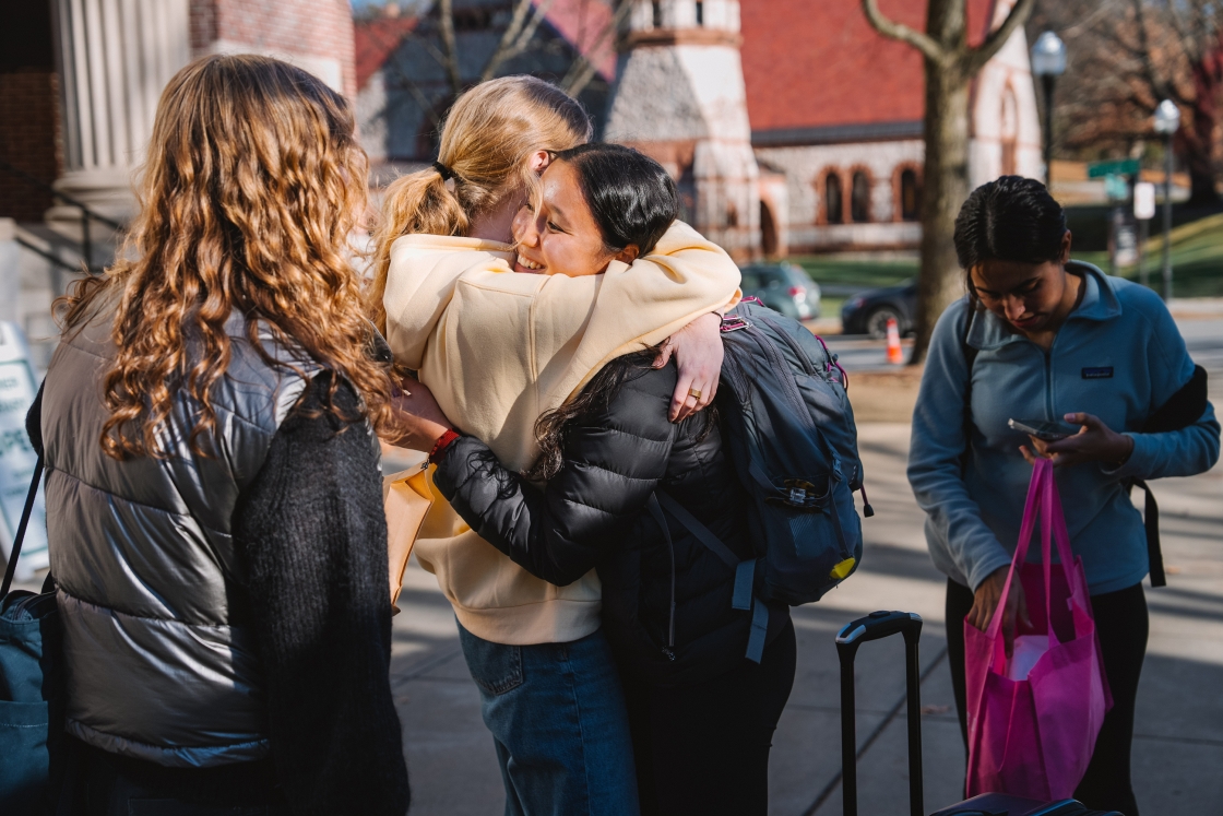 Two students hug as they depart home for the holidays.