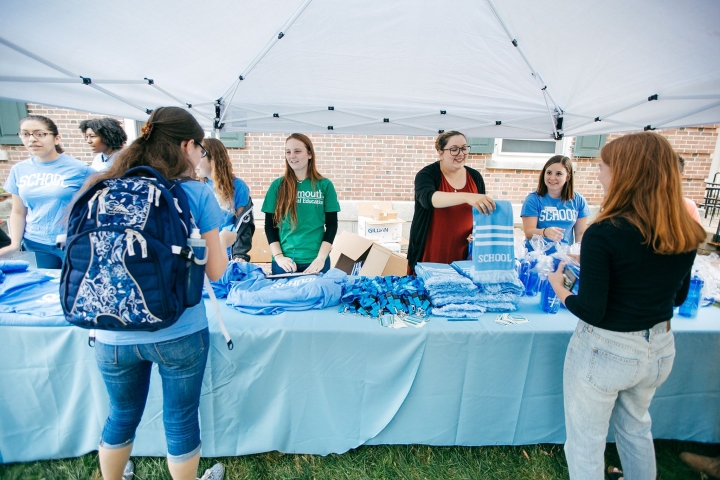 Handing out light blue &quot;school&quot; house scarves