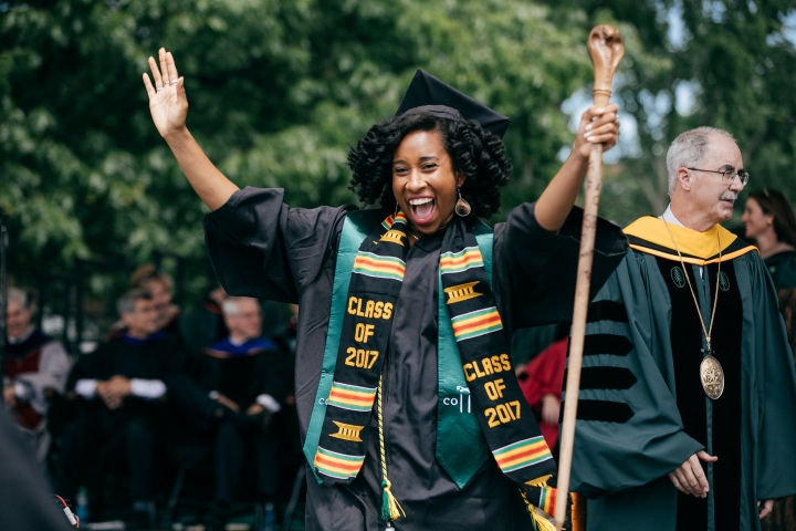 Student holding a commencement cane