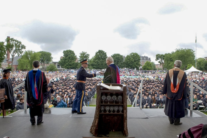 Chris Koppell shakes hands with Jim Wright onstage at commencement