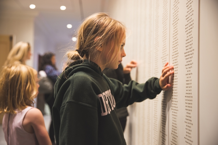 Annie Hampton points to her grandmother's name of the wall of Dartmouth Hall