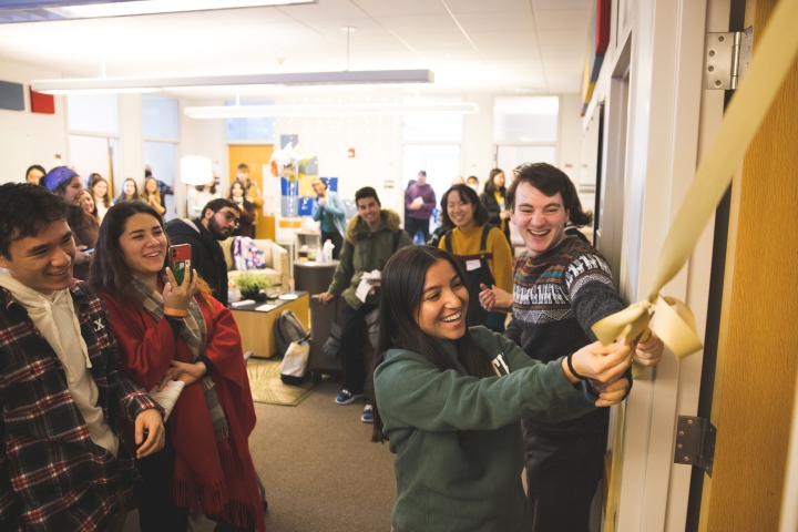 Students cut the ribbon to a new room with massage chairs.