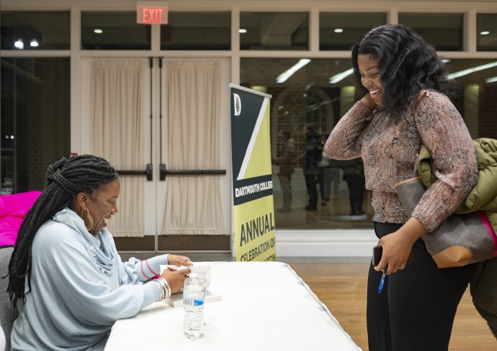 Tarana Burke signing a book for Mikala Ulter