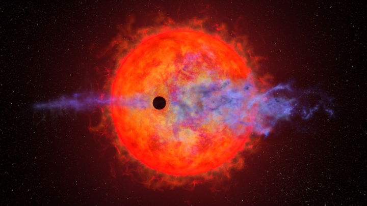 Shadow of planet passing in front of red sun 