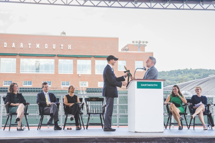 Lee Coffin passing baton to Scott Brown on Memorial Field