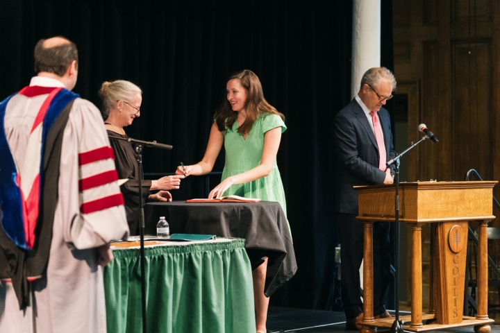 Student signs Phi Beta Kappa book.