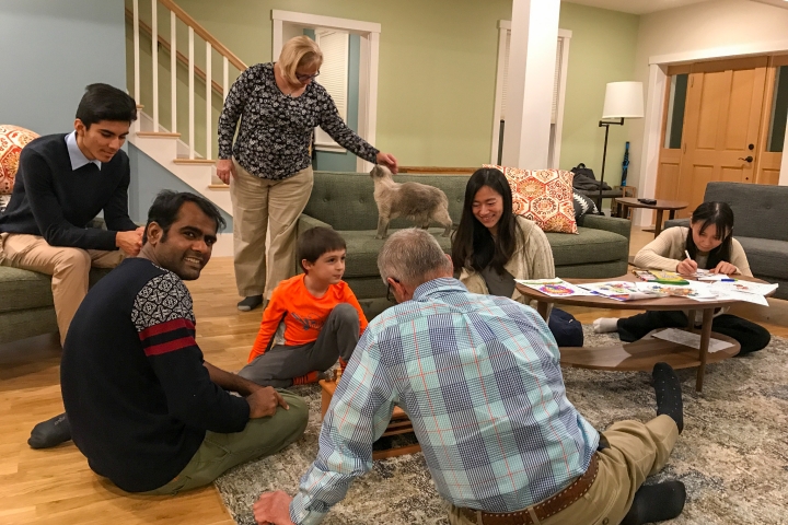 Students and members of Janice McCabe's family play games and color