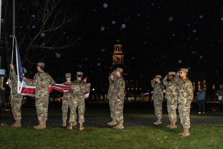 Students in uniform on the Green by the flag