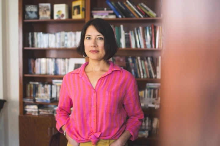 Desirée Garcia in front of a bookshelf