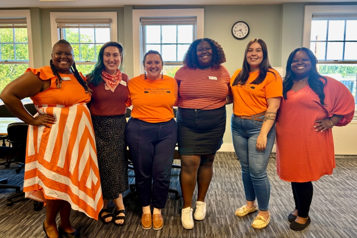 Staff in orange shirts