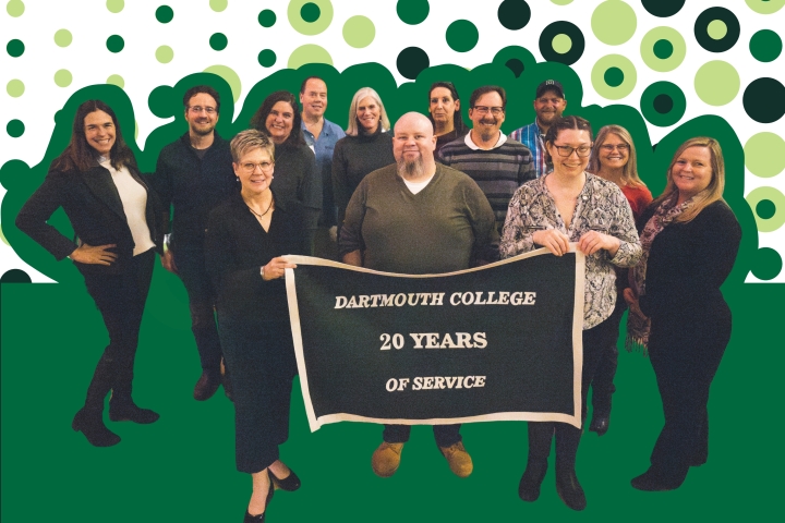 A group of Dartmouth College employees celebrating 20 years of service stand and smile