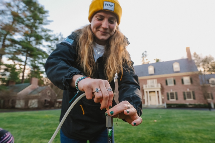 Anneliese Henrich connecting a vacuum hose to a metal soil probe