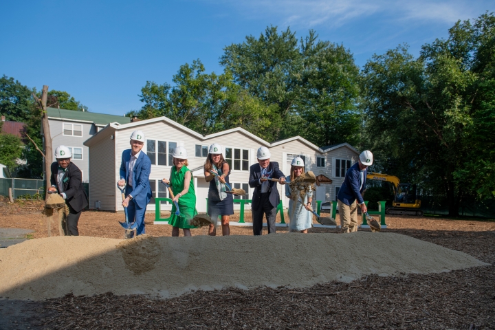 People ceremoniously shoveling dirt