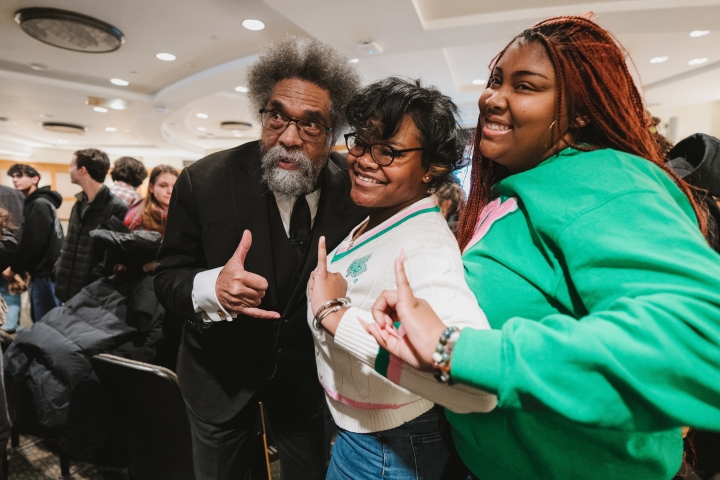 Cornel West and students hand signaling the &quot;shaka&quot; sign