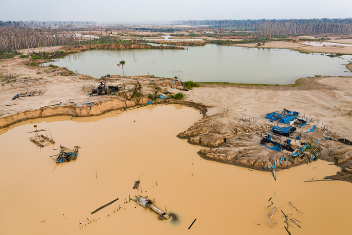 Blue plastic tarps litter an abandoned mining camp in the Madre de Dios, Peru. Actions by the Peruvian National Guard under Operation Mercury led to the removal of illegal miners in the area.