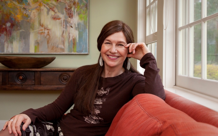 Louise Erdrich '76 sits on a couch at Dartmouth's Montgomery House