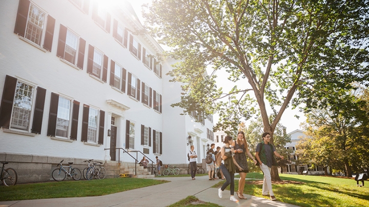 a group of students walking on the sidewalk outside of Dartmouth Hall