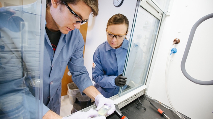 a man and woman working in a lab