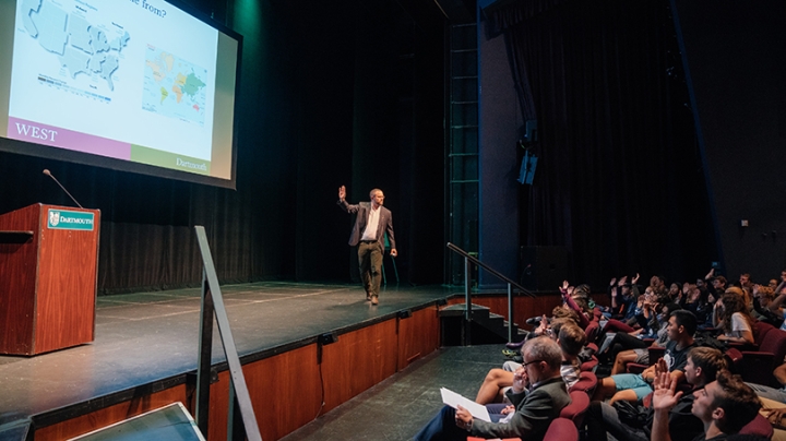 Ryan Hickox speaking to an auditorium full of students