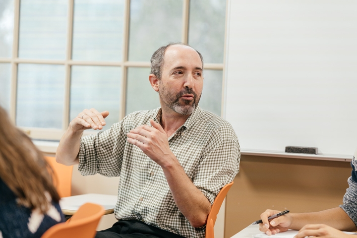 Professor Michael Herron talks with students during a class in the quantitative social sciences program in 2017. 