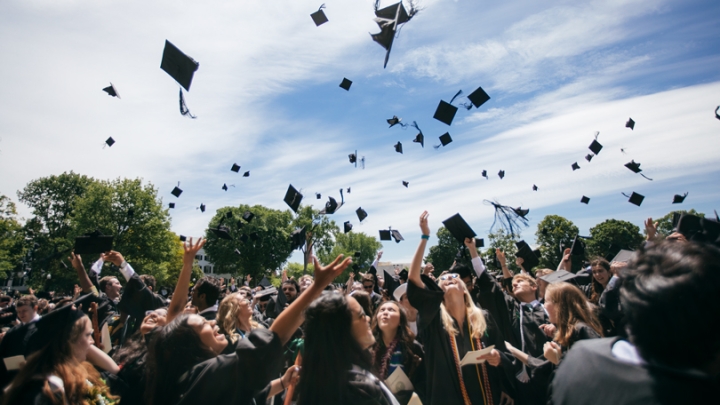 Graduates throw their caps in the air