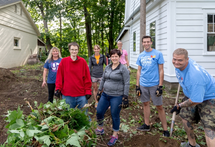 Dartmouth staff pulling vines out of the yard at the Upper Valley Haven