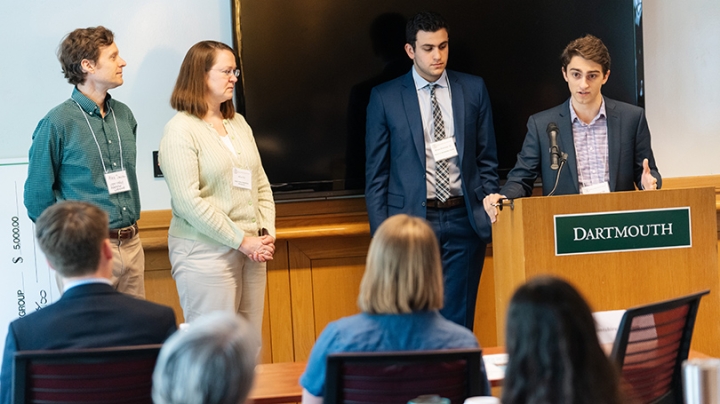 A student speaks at a podium in a classroom