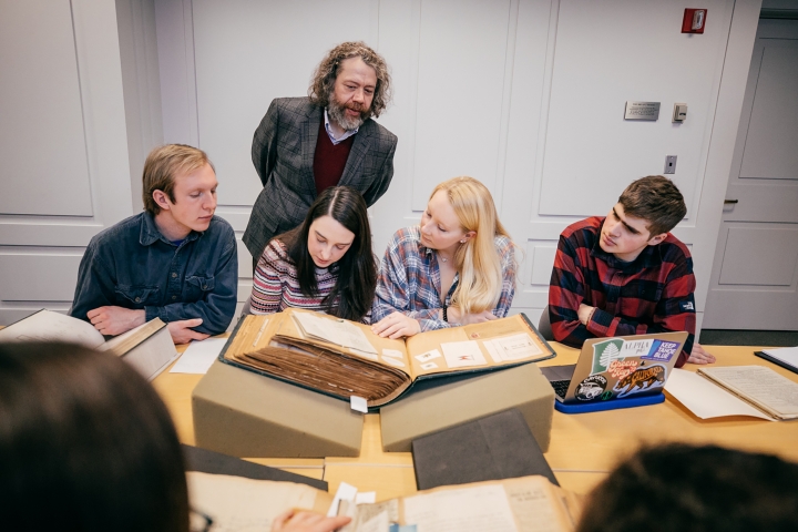 Professor Michael Chaney, standing, and students in his 19th-century American literature class at Dartmouth