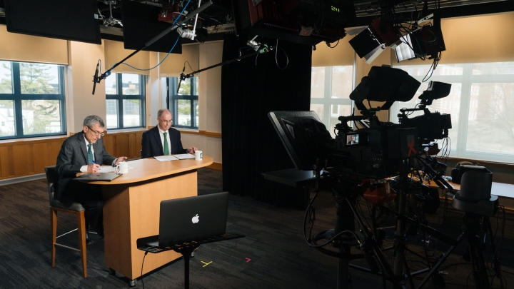 President Philip J. Hanlon '77, right, and Provost Joseph Helble prepare to speak to the community at the March 18 virtual town hall meeting. 