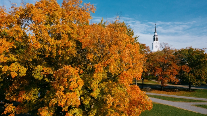 Baker Tower surrounded by orange, yellow, and green foliage