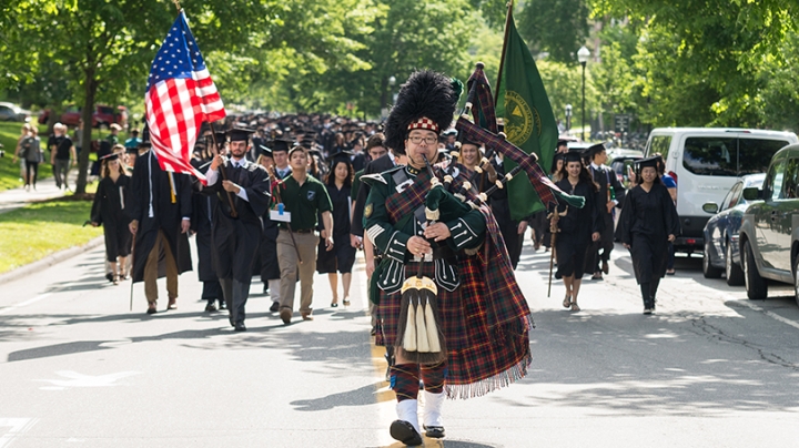 Joshua Marks leading the commencement procession with his bagpipes