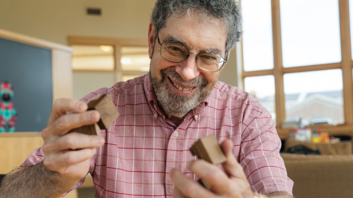 Math and computer science professor Peter Winkler, who will lead "A Year of Puzzles" at the National Museum of Mathematics in New York, assembles a wooden puzzle that proves the equation for the sum of consecutive squares.