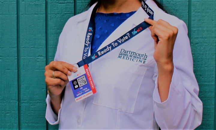 Amal Cheema, Geisel '23, wears a VotER badge with information to help register patients to vote.
