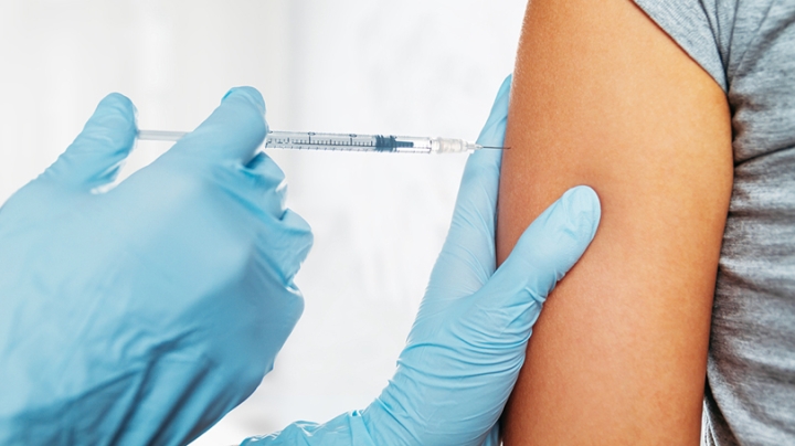 a doctor giving a vaccine to a patient