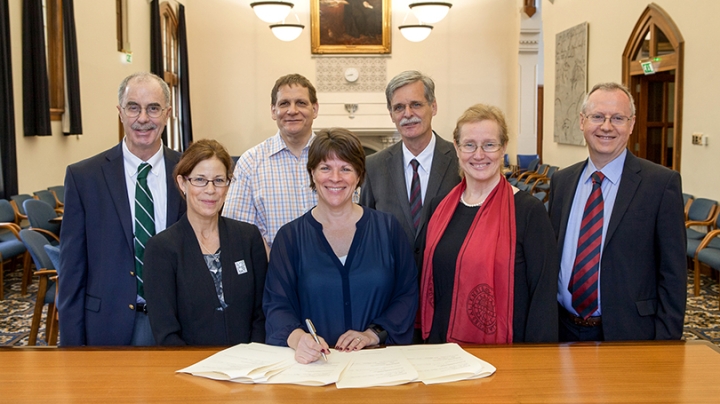 a group of people sitting behind a table