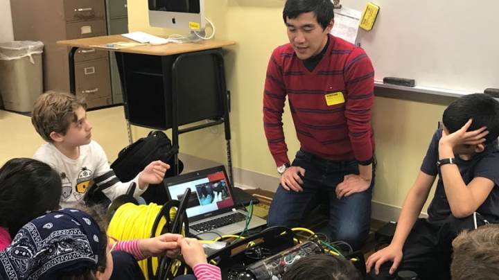 Professor Alberto Quattrini Li demonstrates an underwater robot and a small ground robot