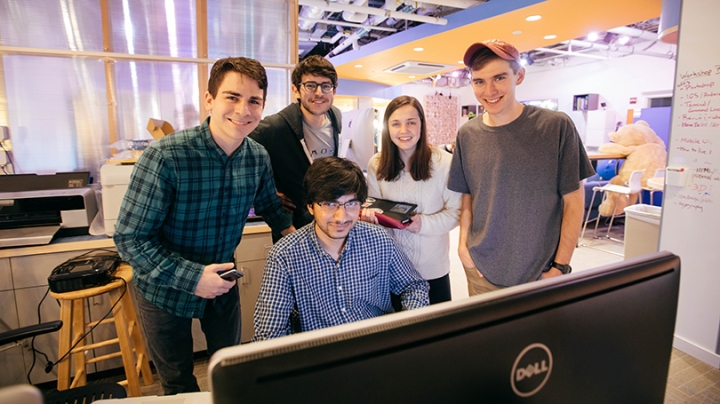 students gathered around a computer at Dartmouth's Dali Lab